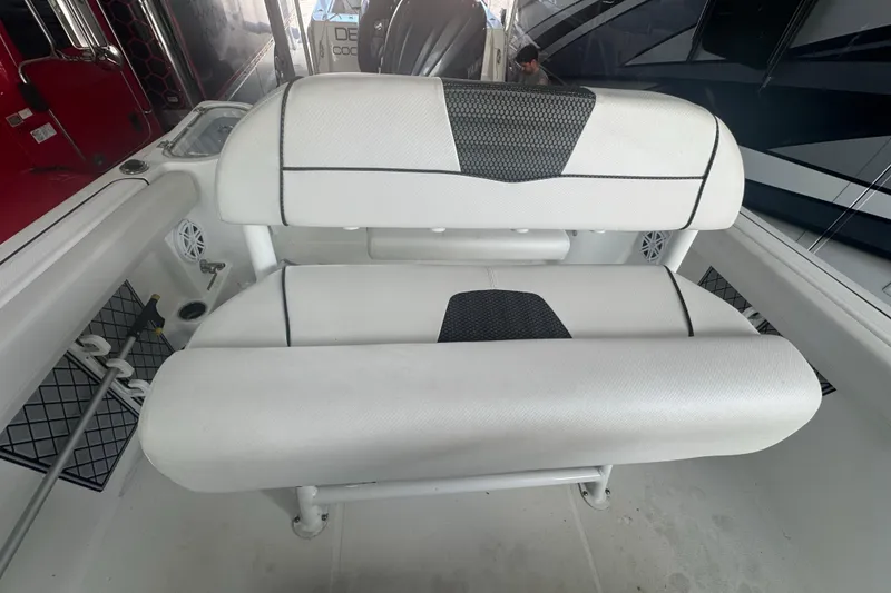 Slide: The Image of 2023 Wellcraft 242 Fisherman boat interior with cushioned seating and storage features. - 39