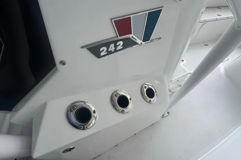 Slide: The Image of 2023 Wellcraft 242 Fisherman boat detail with logo and rod holders. - 40