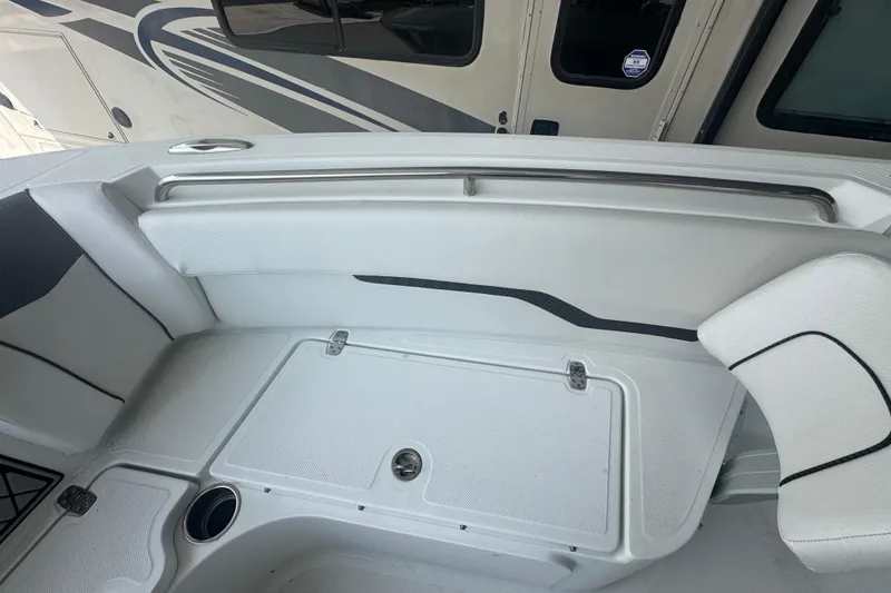 Slide: The Image of 2023 Wellcraft 242 Fisherman boat interior with white seating and storage compartments. - 44