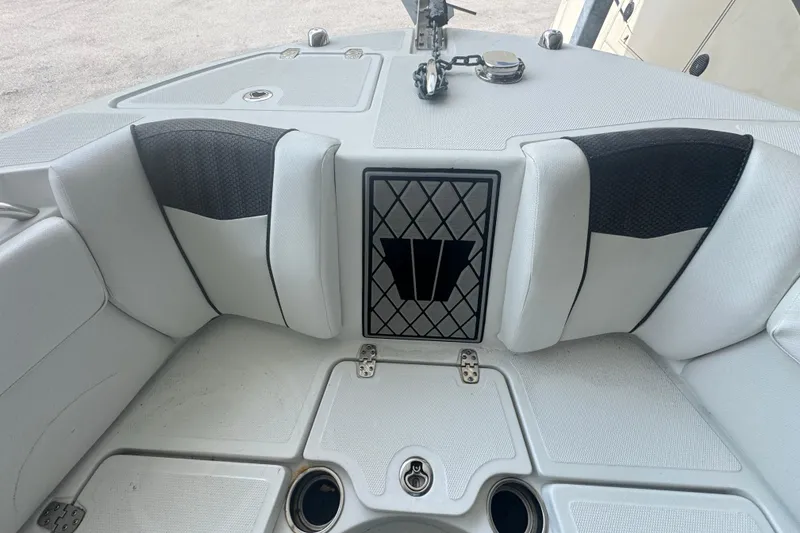 Slide: The Image of 2023 Wellcraft 242 Fisherman boat interior with cushioned seating and storage compartments. - 45