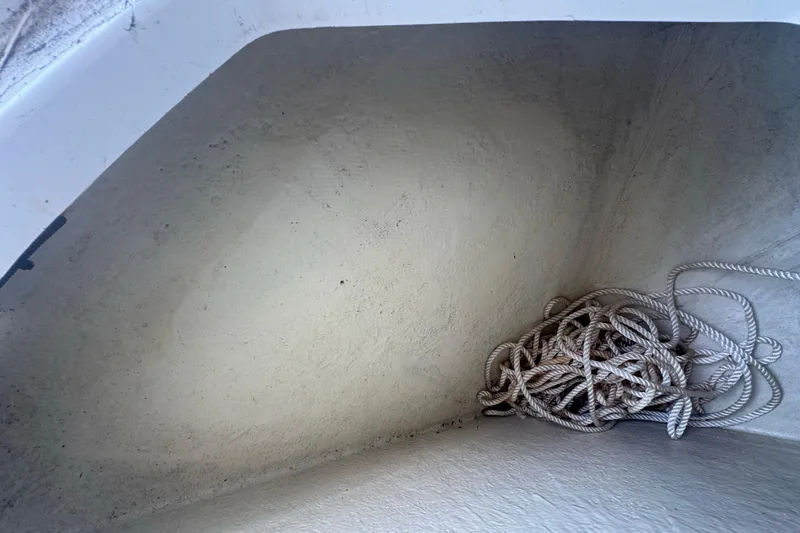 Slide: The Image of Rope stored in a compartment of a 2023 Wellcraft 242 Fisherman boat. - 47