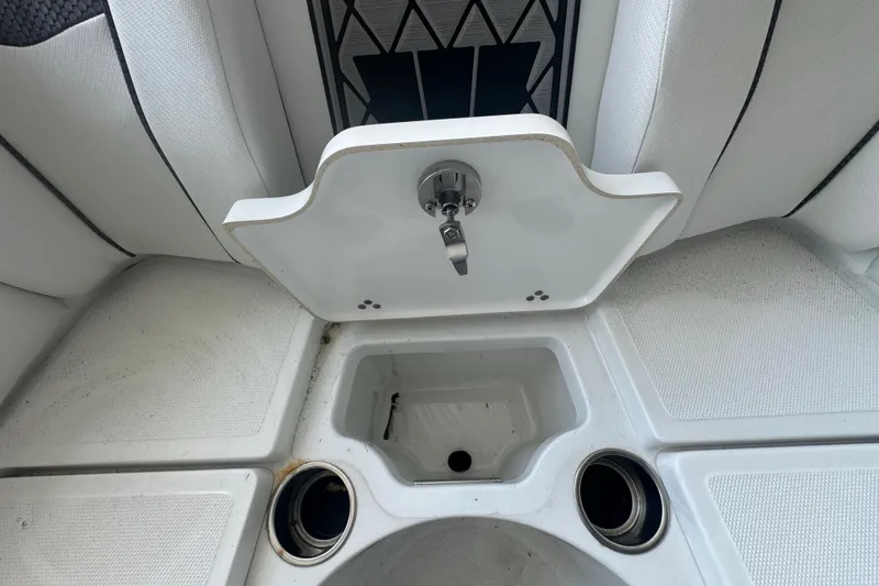 Slide: The Image of 2023 Wellcraft 242 Fisherman boat interior with storage compartment and cup holders. - 50