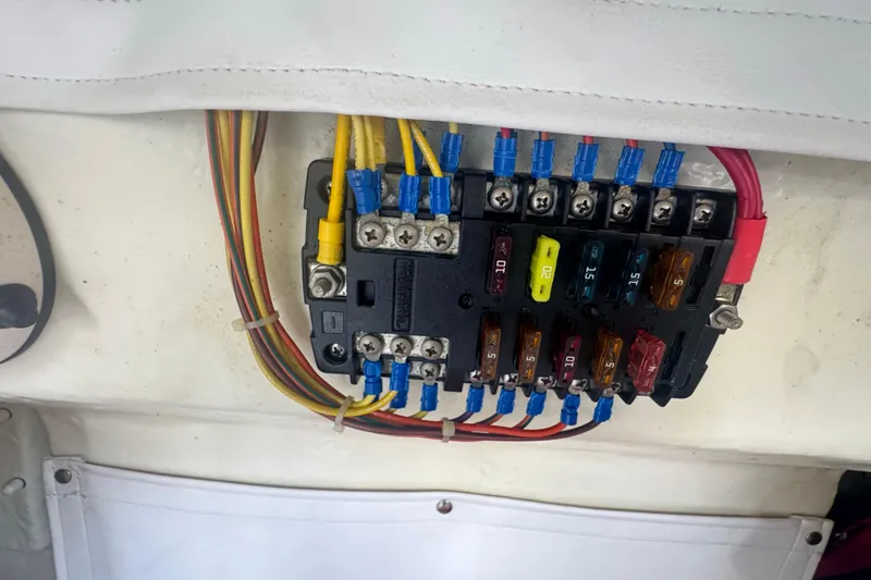 Slide: The Image of Electrical fuse panel on 2023 Wellcraft 242 Fisherman boat with colored wiring connections. - 55