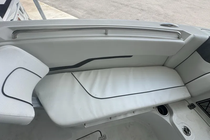 Slide: The Image of 2023 Wellcraft 242 Fisherman boat interior seating with white upholstery and black accents. - 59