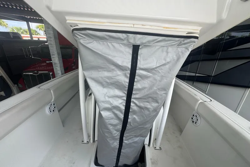 Slide: The Image of 2023 Wellcraft 242 Fisherman boat interior with protective cover and seating area. - 61