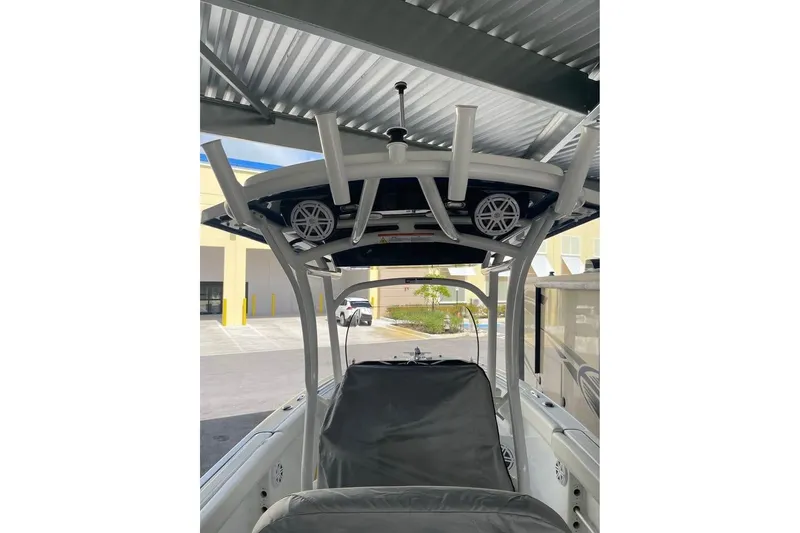 Slide: The Image of 2023 Wellcraft 242 Fisherman with Yamaha 300 V6 4.2L engine under a metal roof. - 7