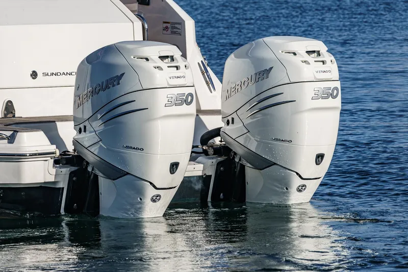 Slide: The Image of Twin Mercury 350 engines on a 2023 Sea Ray Sundancer 320 OB in water. - 12