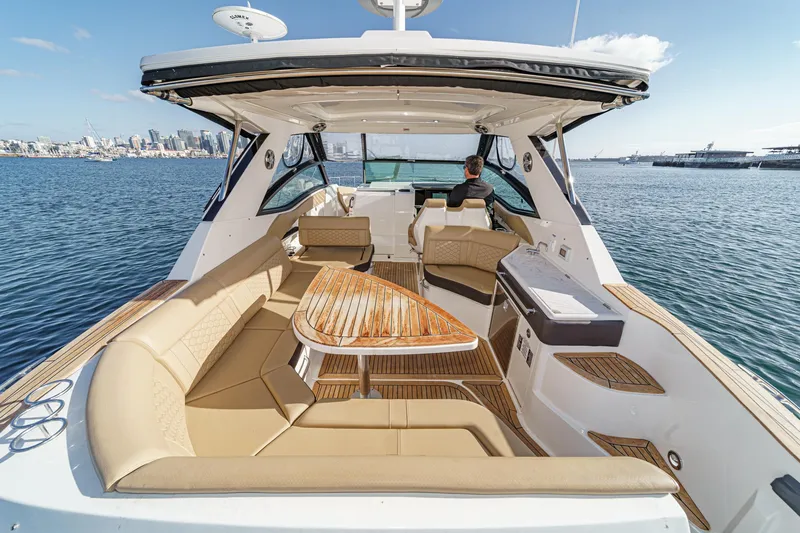 Slide: The Image of 2023 Sea Ray Sundancer 320 OB luxury boat with spacious seating and elegant design on the water. - 13