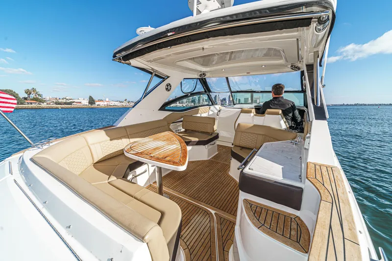 Slide: The Image of 2023 Sea Ray Sundancer 320 OB luxury boat interior with seating and table on open water. - 14