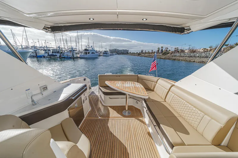 Slide: The Image of 2023 Sea Ray Sundancer 320 OB interior with elegant seating and scenic marina view. - 16