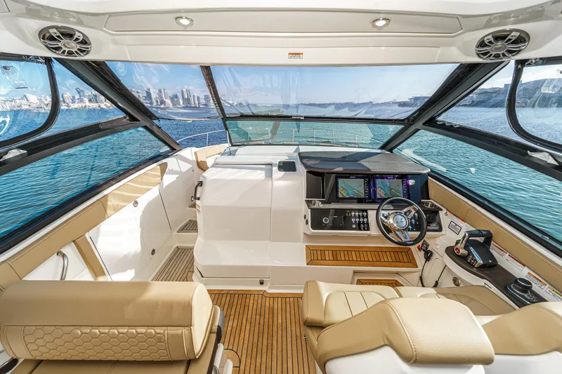 Slide: The Image of 2023 Sea Ray Sundancer 320 OB cockpit with modern controls and panoramic ocean view. - 20