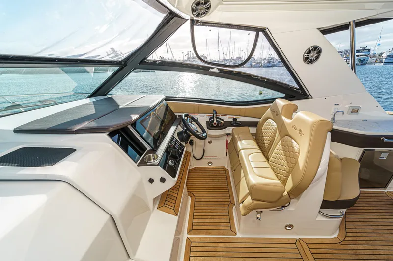 Slide: The Image of 2023 Sea Ray Sundancer 320 OB cockpit with luxurious seating and modern controls. - 21