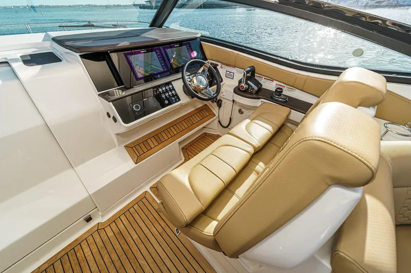 Slide: The Image of 2023 Sea Ray Sundancer 320 OB cockpit with modern controls and luxurious seating. - 22