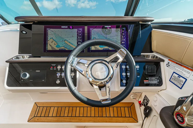 Slide: The Image of 2023 Sea Ray Sundancer 320 OB helm with dual navigation screens and modern controls. - 23