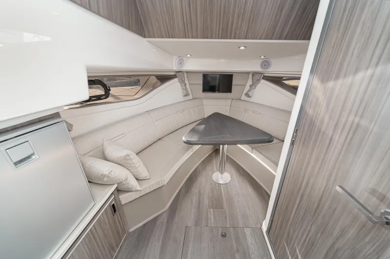 Slide: The Image of 2023 Sea Ray Sundancer 320 OB cabin interior with modern seating and table. - 31
