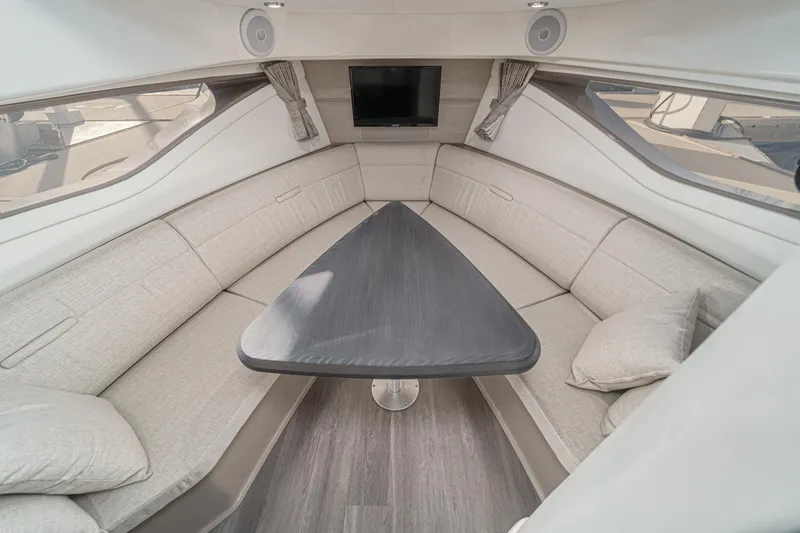 Slide: The Image of Luxurious interior of 2023 Sea Ray Sundancer 320 OB yacht with elegant seating and table. - 32