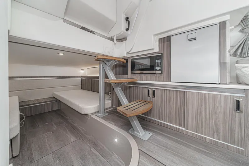 Slide: The Image of 2023 Sea Ray Sundancer 320 OB cabin interior with modern design and compact amenities. - 34