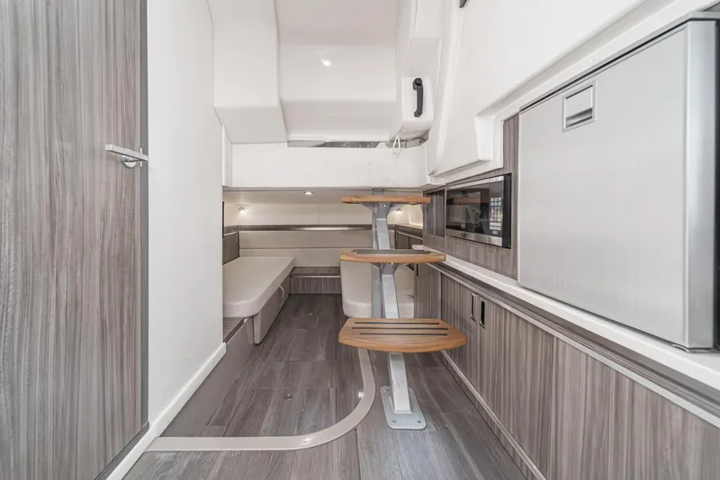 Slide: The Image of 2023 Sea Ray Sundancer 320 OB interior with modern design and wooden accents. - 35