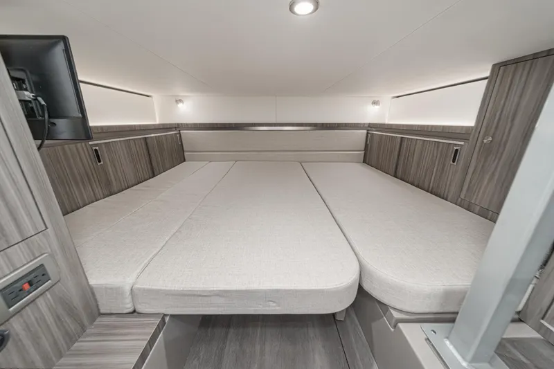 Slide: The Image of 2023 Sea Ray Sundancer 320 OB cabin interior with spacious bed and modern design. - 38