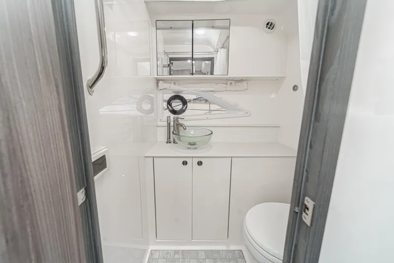 Slide: The Image of 2023 Sea Ray Sundancer 320 OB bathroom with modern fixtures and sleek design. - 39