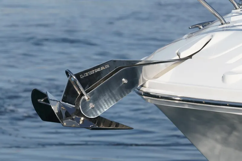 Slide: The Image of 2023 Sea Ray Sundancer 320 OB anchor detail against a serene water backdrop. - 7