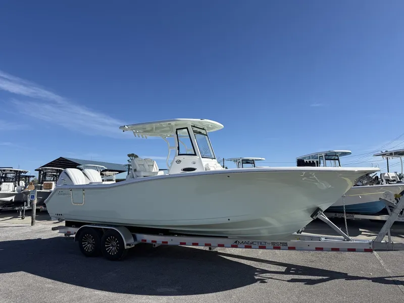 The Image of 2026 Tidewater 282 CC Adventure boat on trailer under sunny skies. - 1