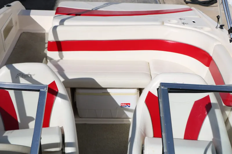 Slide: The Image of Interior of a 2002 Rinker Captiva 192 with red and white seating. - 25