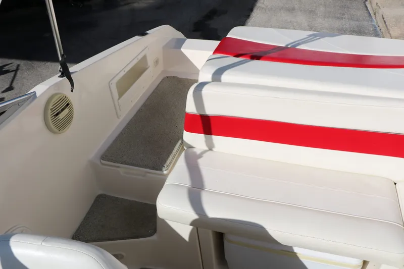Slide: The Image of Interior of a Rinker Captiva 192 boat, white seats with red stripes. - 31