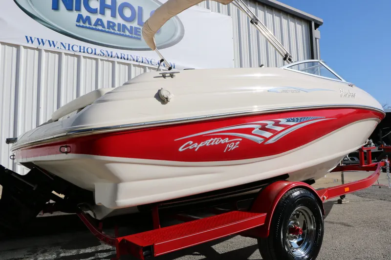 Slide: The Image of 2002 Rinker Captiva 192 Liberty Edition boat on red trailer. - 7