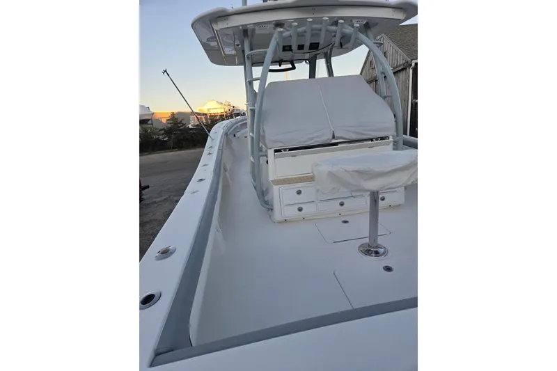 Slide: The Image of 2019 Regulator 41 boat deck with seating and storage, under a clear sky. - 12