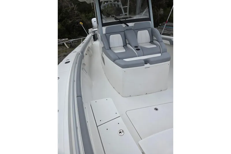 Slide: The Image of 2019 Regulator 41 boat interior with cushioned seating and sleek design. - 13