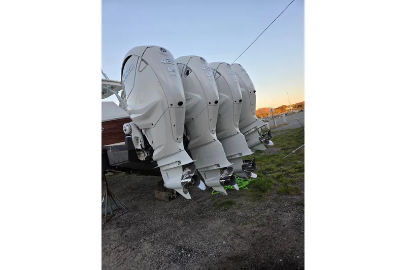 Slide: The Image of Four Yamaha outboard motors on a 2019 Regulator 41 boat, parked on grass. - 21