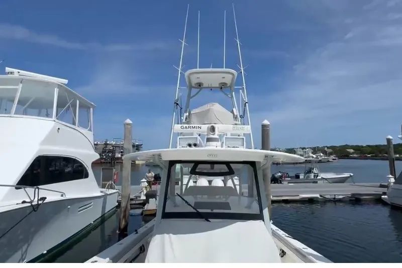 Slide: The Image of 2019 Regulator 41 boat docked at marina under clear blue sky. - 4