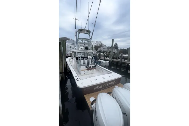 Slide: The Image of 2019 Regulator 41 boat docked, featuring multiple outboard engines and fishing equipment. - 5