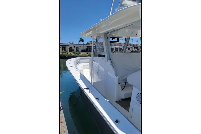 Slide: The Image of 2019 Regulator 41 boat docked, showcasing sleek design and spacious deck. - 7
