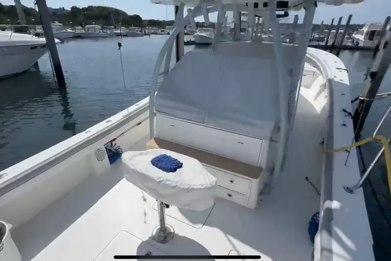 Slide: The Image of 2019 Regulator 41 boat docked, featuring spacious deck and seating area. - 8