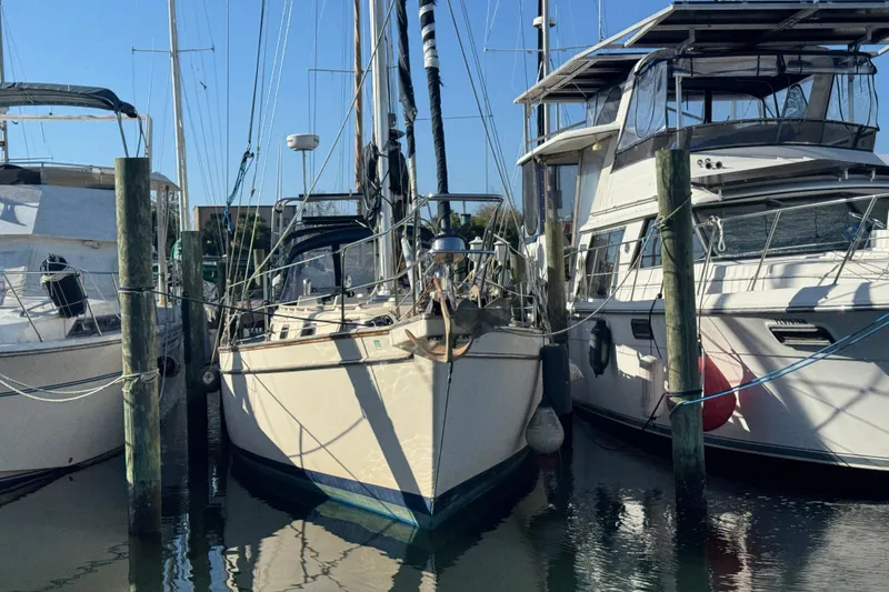 The Image of 1991 Island Packet Yachts 38 docked between two boats in a marina. - 0