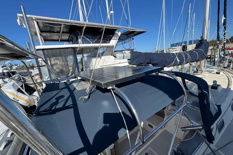 Slide: The Image of 1991 Island Packet Yachts 38 sailboat with solar panel and covered cockpit in marina. - 10