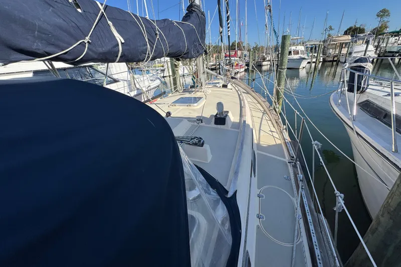 Slide: The Image of 1991 Island Packet Yachts 38 sailboat docked in a marina, showcasing deck and rigging. - 13