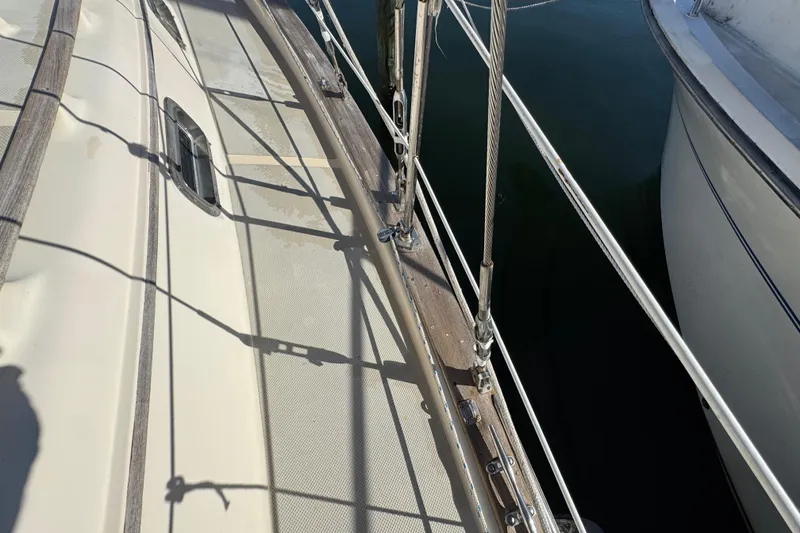 Slide: The Image of Deck view of a 1991 Island Packet Yachts 38, showing rigging and railing details. - 14