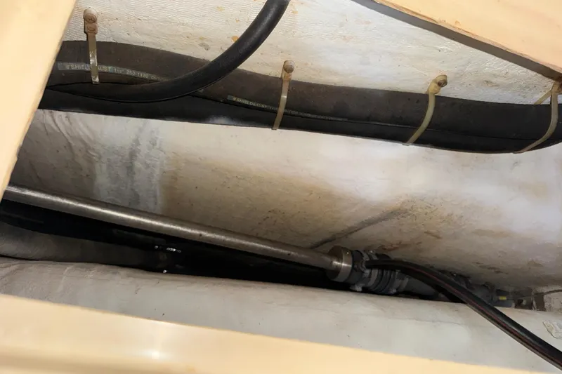 Slide: The Image of Interior view of 1991 Island Packet Yachts 38 showing pipes and cables. - 26