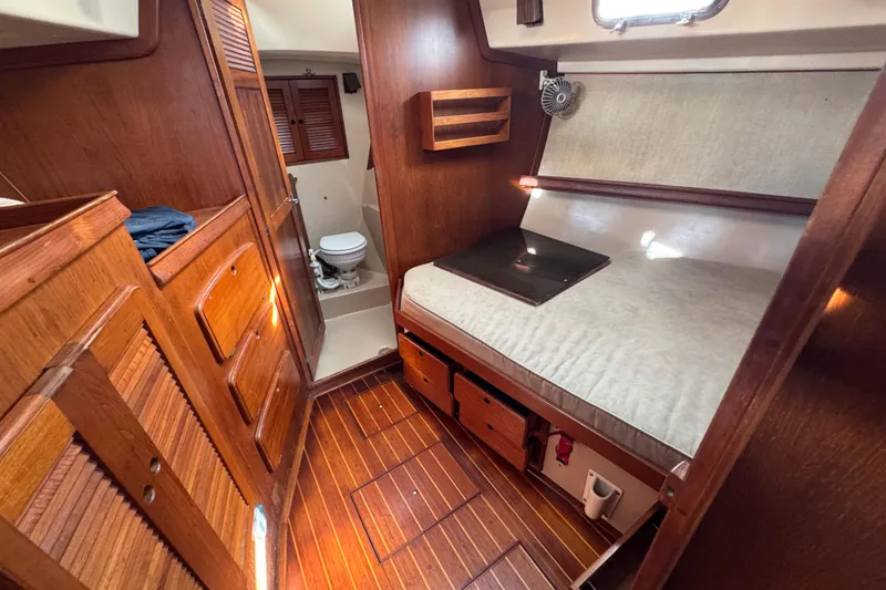 Slide: The Image of Interior of a 1991 Island Packet Yachts 38, featuring a cozy cabin and compact bathroom. - 30