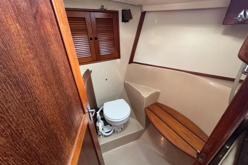 Slide: The Image of 1991 Island Packet Yachts 38 bathroom with wooden accents and compact design. - 31