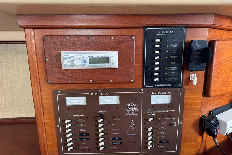 Slide: The Image of Electrical panel of a 1991 Island Packet Yachts 38, featuring switches and gauges. - 32