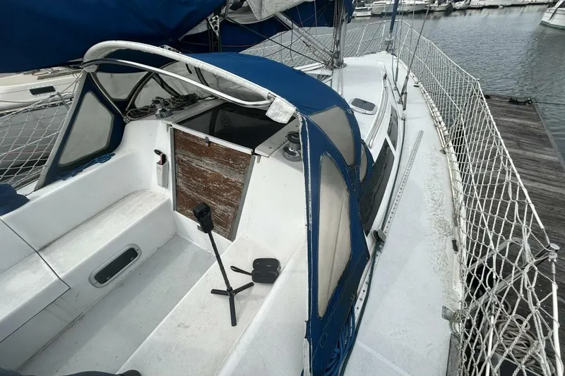Slide: The Image of 1995 Catalina 320 sailboat with blue canopy docked at marina. - 37