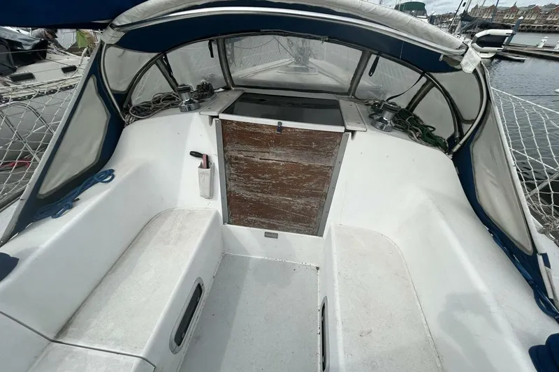 Slide: The Image of Cockpit of a 1995 Catalina 320 sailboat with wooden hatch and seating. - 38