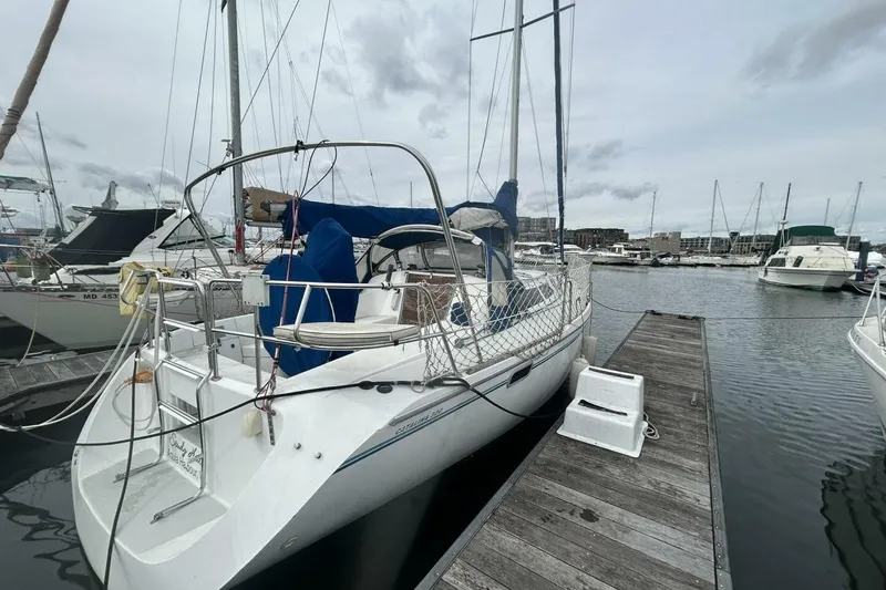Slide: The Image of Sailboat Catalina 320, 1995 model, docked at marina with overcast sky. - 39