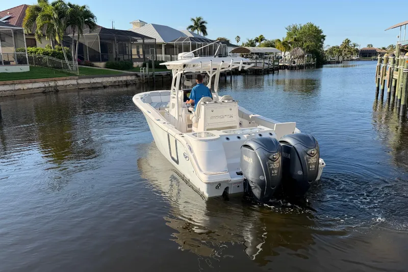 Slide: The Image of 2022 Sea Fox 288 Commander boat cruising in a scenic canal setting. - 29