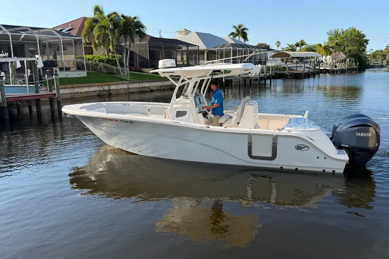 Slide: The Image of 2022 Sea Fox 288 Commander boat on calm water near residential docks. - 30