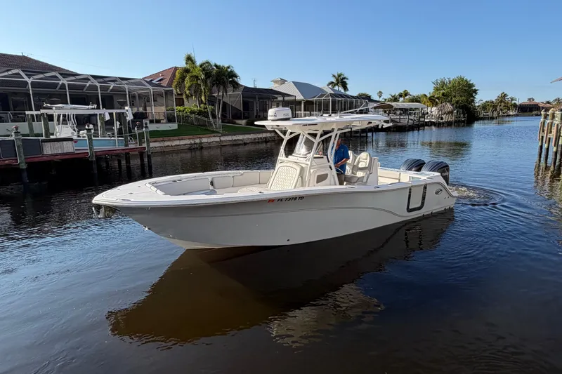 Slide: The Image of 2022 Sea Fox 288 Commander boat cruising in a calm residential canal. - 31